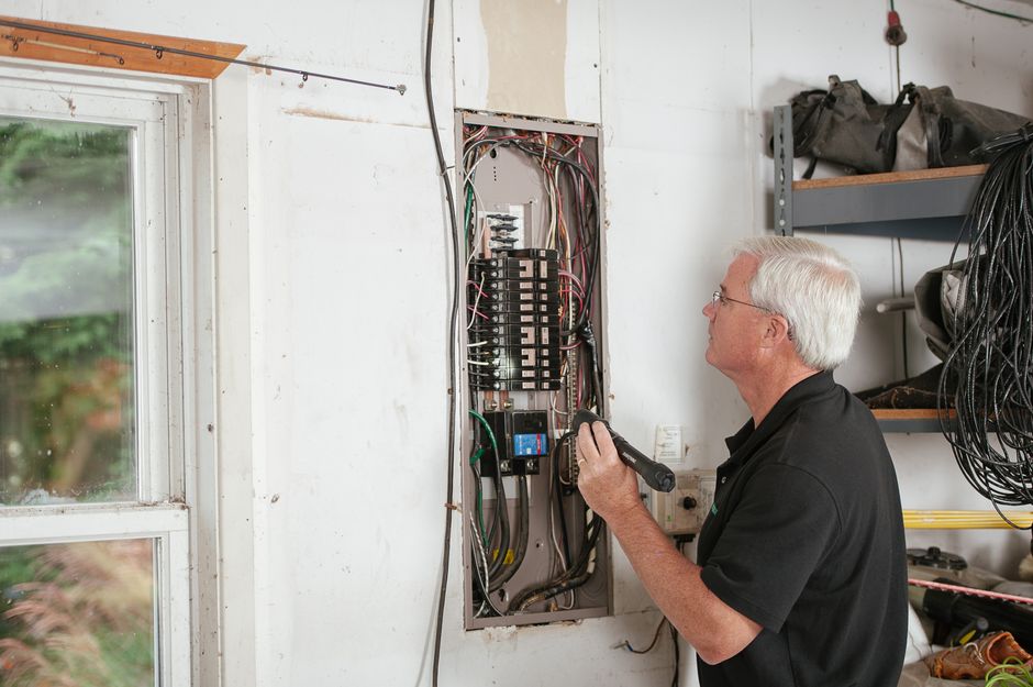 Licensed electrician working on residential wiring panel